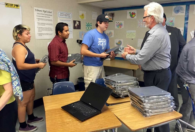 Jim Vigdor, Alcoa, Simi Valley, passes out laptops on behalf of the Alcoa Foundation.