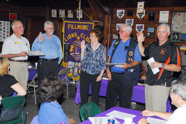 Fillmore Lions Club welcomed two new members, Monday night. Gerald and Susan Fitzgerald (second from left and center) are shown being sworn in my Lion Bill Dewey, Bill Edmonds and District Governor Dan Lyon.