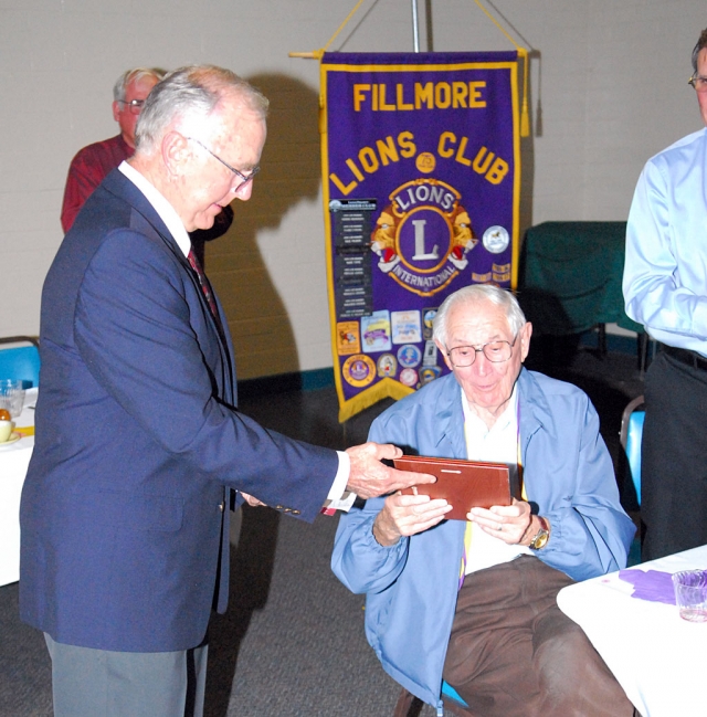 Seated is Frank Dunst, who was honored for 60 years of Lions Membership and service. Lion Bill Dewey, standing, presented Dunst with a plaque celebrating his amazing life and tenure in Lions. On June 15 at the Memorial Building over 50 Lions, spouses, and friends celebrated the 82nd annual Installation and Award dinner. It was a very successful evening. Lion President Bill Edmonds presented award to his 2008-2009 cabinet and thanked everybody for their enthusiastic work during this past year. Then Lion President Joe Woodruff installed the new cabinet for the coming year. Special awards were presented. Lion Scott Lee presented the Lion of the Year Award to Paul Schifanelli for his tremendous work on behalf of the club this year. Then the prestigious Melvin Jones Award was given to Ron Smith. This is a lifetime achievement award. Then Jim Austin presented the Proud Lion Awards to April Hastings, and Sean Hastings. The Hastings’ are new Lions members who completed a very rigorous program which includes attending a board meeting, bringing a prospective new Lion to a Meeting, attending a zone or district cabinet meeting, visiting another club, and participating in a Club Fund Raising or Service project. The Hastings' sponsor is Lion Mary Tipps. The final award given was a Donald Snyder Student Speaker Foundation award to Pres. Bill Edmonds for his continuing work in the annual student speaker contest. 