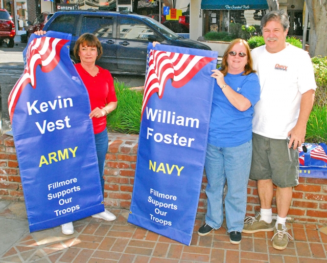 Proud military parents of Kevin Vest and William Foster are pictured on March 8th holding some of the banners hung on Central Avenue, honoring military service personnel.