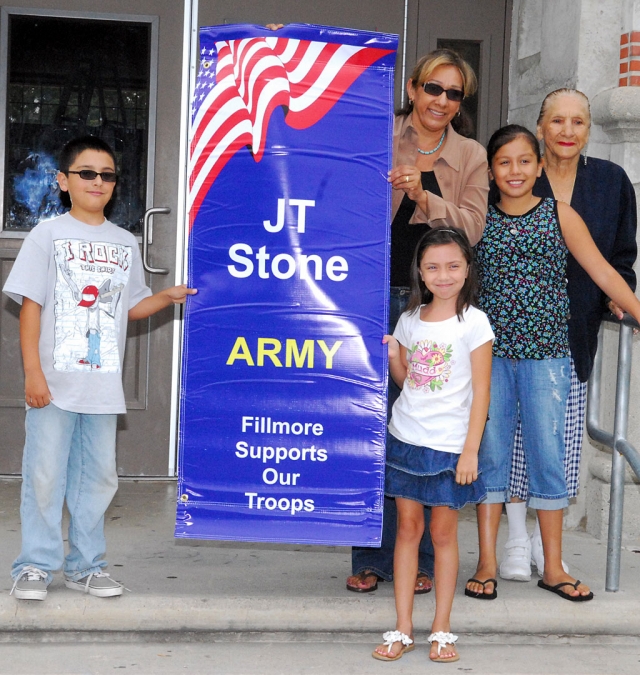 Family members of J.T. Stone proudly hold his banner.