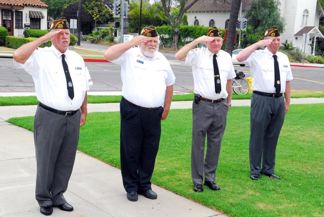 Pictured (l-r) are Vic Westerberg, Jim Mills, John Pressey, and John Hart, Veterans of Foreign Wars Post 9637, saluting at the banner hanging.