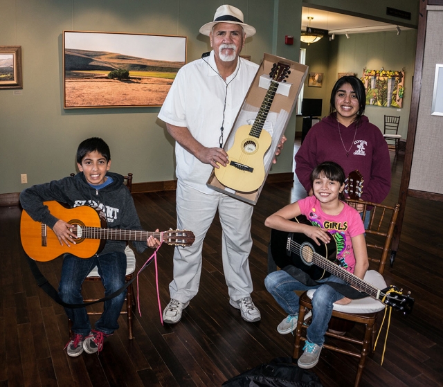 Program Director Xavier Montes with three of his talented Strings Program students. 