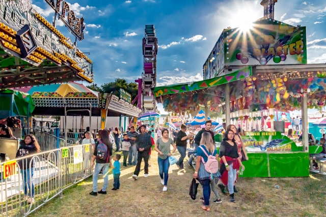 Photo of the Week "May Festival Midway & Sunstar" by Bob Crum. Photo data: Canon 7DMII, manual mode, Tamron 16-300mm lens @16mm. Exposure; ISO 1600, aperture f/22, shutter speed 1/250 of a second.