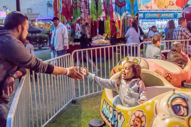 Photo of the Week "Girl and father both enjoying the experience" by Bob Crum. Photo data: Camera Canon 7D MKII Manual mode, ISO 10,000, Tamron 16-300mm lens @ 28mm, aperture f/11, shutter speed 1/125 second. 