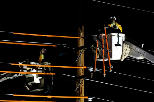 Photo of the Week "At midnight, workers preparing high-voltage wires for pole replacement" by Bob Crum. Photo data: Canon 7D MKII camera in manual mode, Tamron 1.4 teleconverter & 16-300mm lens @340mm. Exposure; ISO 3200, aperture f/8.0, 1/50 second shutter speed.