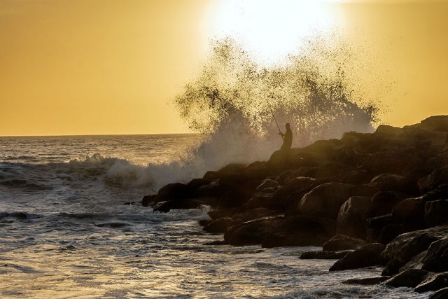 Photo of the Week "Angler silhouette against a giant smashing wave on the jetty" By Bob Crum. Photo data: Canon 7D MKII camera, ISO 250, Tamron 16-300mm lens @70mm, aperture f/11, 1/1000 shutter speed.