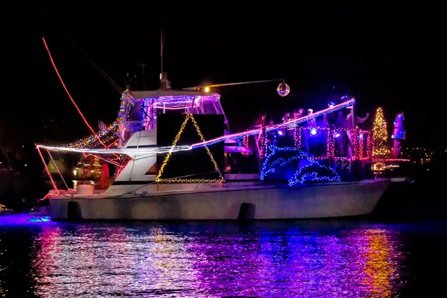 Photo of the Week "Boat #22, Girlie Girl in the Ventura Harbor boat parade" by Bob Crum. Photo data: Canon 7DMKII camera, ISO 12800, Tamron 16-300mm lens @35mm, f/4.5, shutter speed 1/250 seconds.