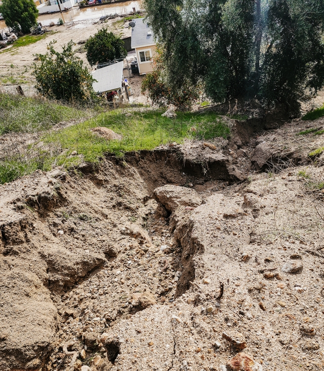 The path of the mudslide viewed from the top of the hill behind the damaged home. 