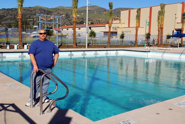 City Council Member and former Mayor Steve Conaway stands in front of the city’s new, almost full, swimming pool. The pool’s chemistry is being adjusted, and the high school swimming team has already had a dip. The state-of-the-art swimming pool-tennis complex will be open for business in April.