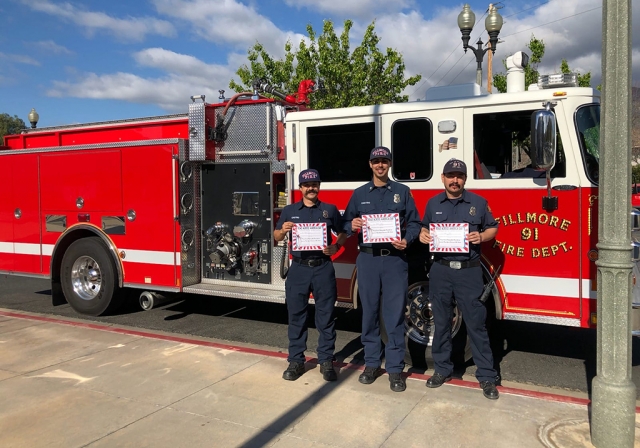Fillmore firefighters holding Read Across America certificates as a thank you for participation. 