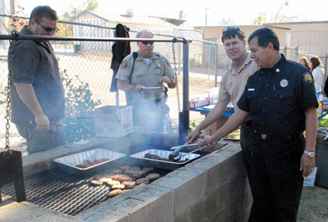 Chief Landeros barbecuing lunch for the students at Sierra High School Sierra in December of 2009