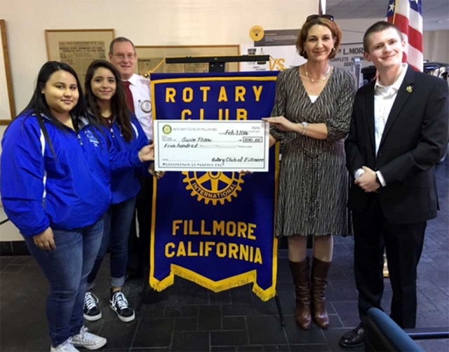 Rotary presents $500 donation to FHS Swim Team. The Rotary Club presented a check for $500 to the FHS swim team. Team members with Kyle Wilson, President and Swim Coach and Teacher, Telana Burns.