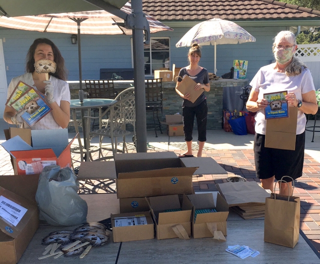 The Rotary Club of Fillmore is working to ensure Preschool children in the community receive Josh the Otter water safety materials before summer. They are partnering with the Fillmore Unified School District. Pictured are Katharine McDowell, Kelli Couse and Cindy Blatt holding up materials while remaining 6 feet apart, practicing social distancing guidelines. Courtesy Martha Richardson.