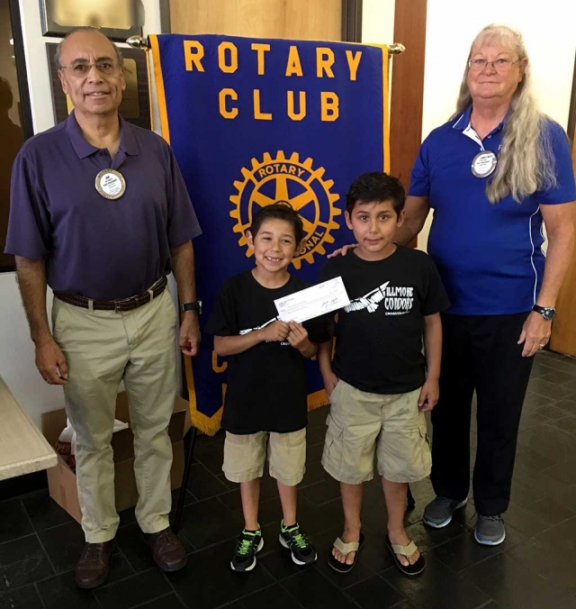 Rotarians Joe Aguirre and Cindy Blatt presented a donation check to Diego & Santiago Felix, members of Condor Youth Cross Country.