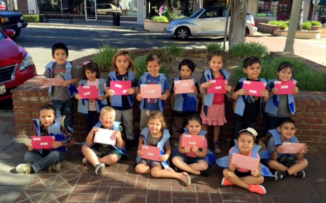 Neither snow, nor rain, nor heat, nor gloom of night stays these couriers from the swift completion of their appointed rounds. The 4-year olds from Sonshine Preschool took a walk down to the Fillmore Post Office in
their postman’s outfits. They had letter to mail, learning about the post office process.