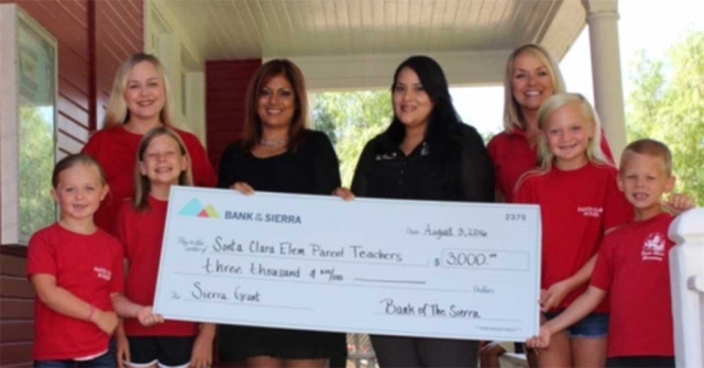 Jennie Andrade, Assistant Vice President, Fillmore Branch, and Adriana Mejia, the Financial Service Representative of the Fillmore Branch presented the check to Kari Skidmore, Principal and Amber McCalister, PTO President and some of the school's children in front of Santa Clara Elementary School.