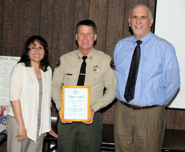 Out going Chief of Police Tim Hagel (center) was presented the “Students First” award during Tuesday night’s school board meeting. Also pictured Virginia De la Piedre and Superintendent Jeff Sweeney.