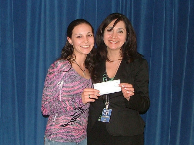 Renae Stovesand, Member of the Sespe School Parent Club is presenting a check to Mrs. Hibbler to purchase AR books with money raised from the Avon fundraiser that the school did in November 2009. The parent club matched that amount so that AR books could be purchased for the library.