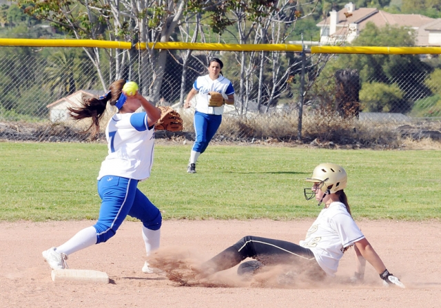 Karinna Carrillo #7, attempts to turn a double play against Oak Park. Outfield is Marissa Vasquez. Fillmore had several hits to the outfield including one by Mary Ortiz that bounced on top of the fence in center field but fell inside the fence. Fillmore lost 9-1.