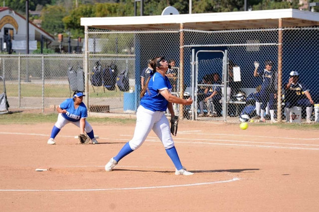 Flashes JV player Zoie Isom pitching to the Santa Clara batters while the Flashes defense sits ready to make a play against Santa Clara. Fillmore beat Santa Clara 12-5.
