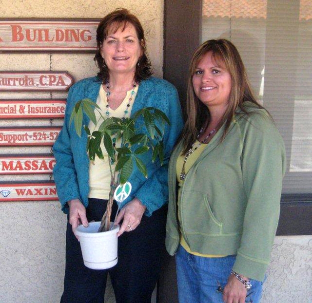 Terri Aguirre (past president) and Ari Larson (upcoming president) with Peace Plant.