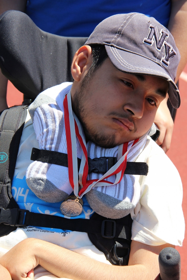 Luis showing off his medals