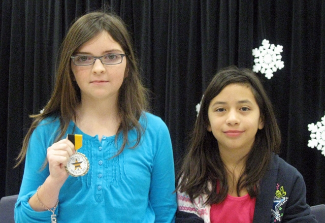 Mt. Vista Elementary Spelling Bee: Pictured are Mishell Beylik (l-r), Mountain Vista Spelling Bee Champion, and runner-up Rebecca Trujillo. Mishell’s championship word was quadrilateral. She will proceed to the Area Bee competition next month.