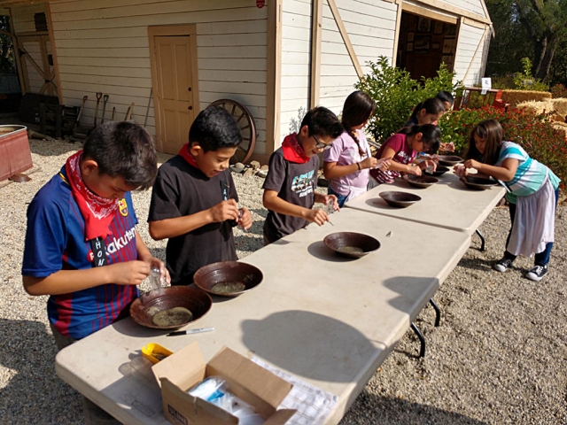 Students learning how to pan for gold just like the pioneers use too.