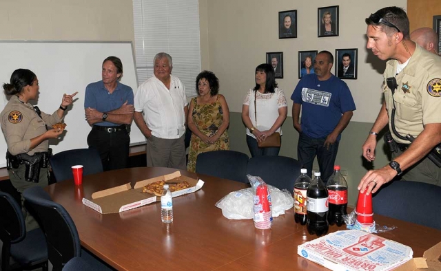 Mr. and Mrs. Pete Aguirre, center, presented the Fillmore Sheriff’s Department with a pizza dinner in appreciation of all they do to serve the community. The Aguirre’s son Pete Aguirre Jr. was killed in the line of duty in 1996. Second from left is Retired Cmd. SPPD Mark Trimple, who provided the dinner.