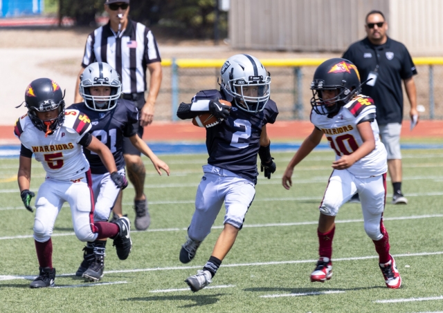 On Saturday, September 14, Raiders Bantam Silver took on the Santa Clarita Warriors and defeated them 32-0. Picture left is Bantams Silver #2 making his way past the Warrior defense to try and gain yards for the Raiders. Photo credit Crystal Gurrola