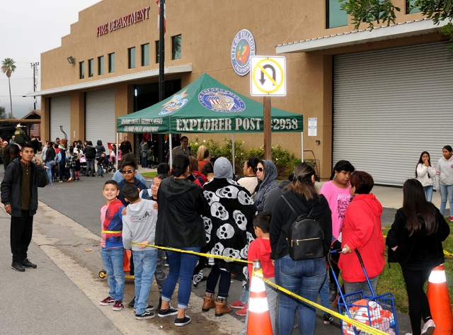 On Saturday morning, December 14th, Fillmore residents lined up at the Fillmore Fire Station for the Annual Toy Giveaway. Each child took a picture with Santa Claus and received a new toy, reading book, a new coat, socks, and holiday bags of groceries. Cotton candy, popcorn and candy canes were handed out. The children and their families were also able to visit with first responders and learn safety tips.