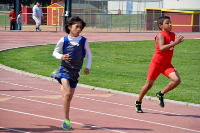 (left) Isaac Ortiz who placed 1st in the 800m dash Midget division.