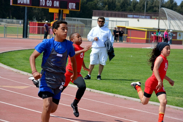 (left) Joshua Morales, Joshua placed 3rd in the 200m midget division and jumped 14 feet 3 inches in ling jump which qualified him for varsity finals.