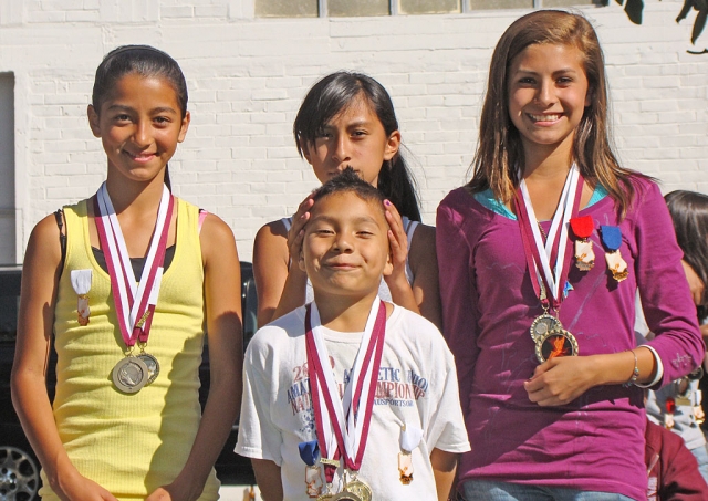 Pictured (l-r) Nayeli Beaz (3rd 3200 girls 13-14); Irma Torres (1st 3200 girls 11-12); Kiana Hope (1st 3200 girls 13-14), Juan Carlos Laureano (1st 1600; 3rd 800 boys 7-8).