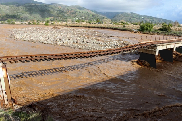 A stretch of railroad track hanging in there, over the Sespe River at Old Telegraph Road. Two weeks of heavy rain took the river to the major flood stage of 20.4-feet. Photo credit Angel Esquivel-AE News.