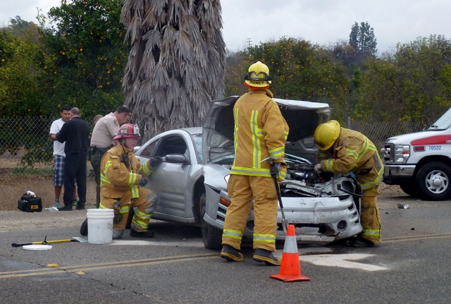 At 10:15am Thursday morning, December 19, a one-car accident took place at Goodenough Road and A Street. The driver, back left, apparently lost control of the car and hit the Palm Tree pictured center. He was treated at the scene.
