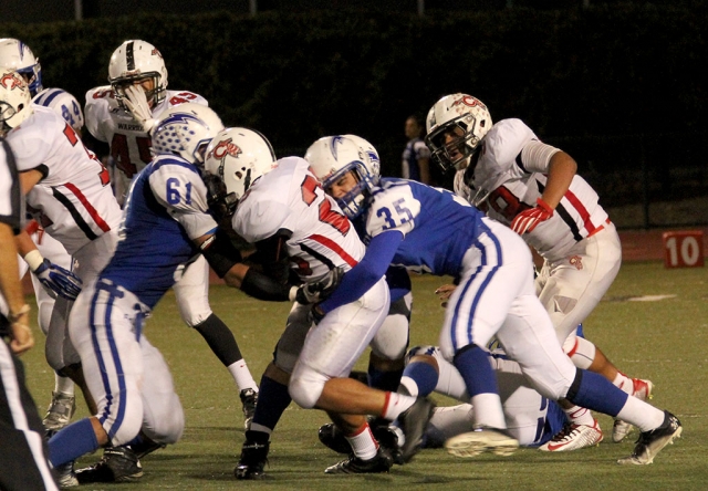 Varsity #35 Emilio Hernandez and #61 Gil Sandoval make the stop