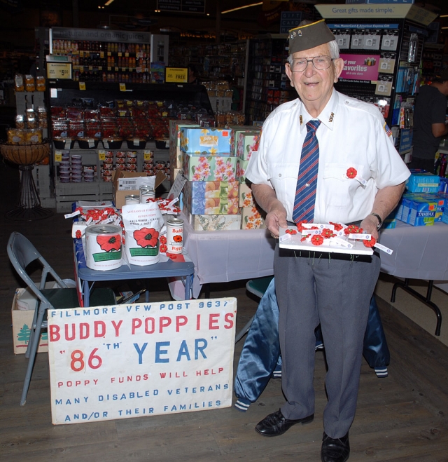 Bud Untiedt, inset, handed out poppies in remembrance of the Veterans of Foreign Wars, Saturday in front of Vons Market.