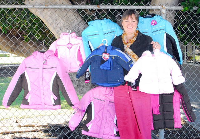 Pictured is Laura Bartels donated coats already received for the Santa Clara Valley Legal Aid’s Third Annual Winter Coat Drive. Laura is the Director.