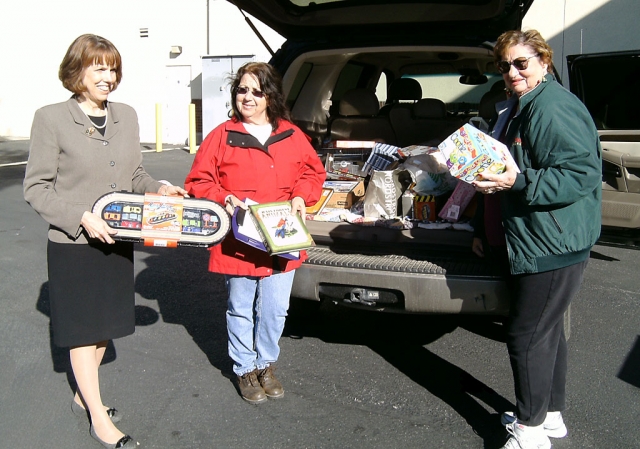 Valerie Richards, Mimi Burns, this years President, and Jeanne Klittich delivering the toys for the foster children.