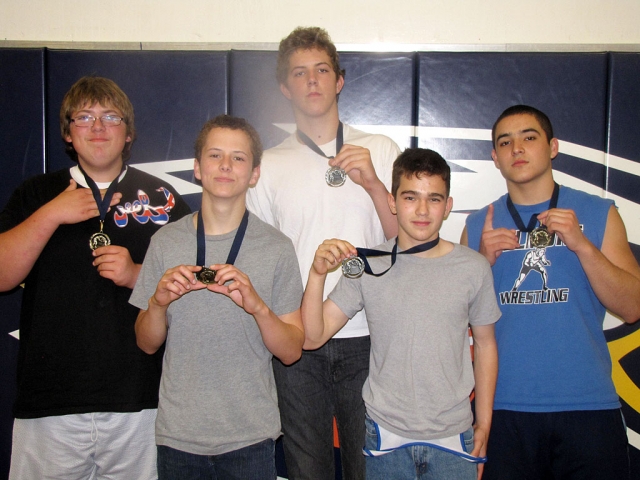 JV (l-r) Andy Vasquez 1st place heavy weight, Nic Stehly 113lbs 1st place, Cameron Riley 220lbs 2nd place, David Cadena 106lbs 2nd place and George Orozco 195lbs 1st place.