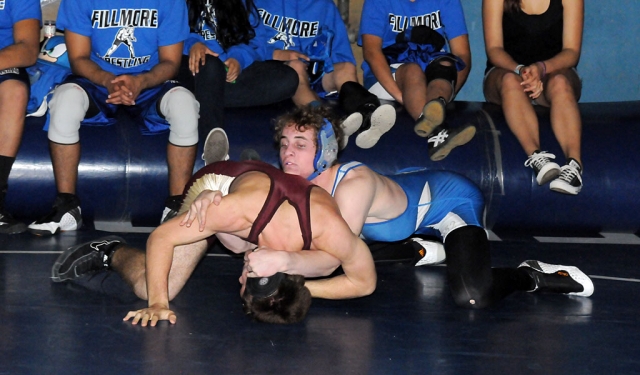 Christian Conaway wrestles against New Jewish Community School. 