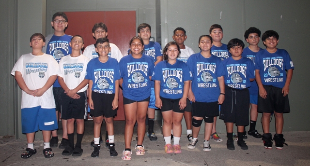 (Above) Fillmore Middle School Wrestling team sporting their new team shirts which were donated by parent Armando Avila and his company Sub-Life. (l-r) Angel Ortiz, Cristian Martinez, Matthew De La Cruz, Naomi Bonilla, Jozlyn Alvarez, Nakia Magallon, Josh Magallon, Abraham Castorena. Back Row: Armando Avila, Fernando Martinez, Sotero Chavez, Jeremiah Chapman, Kobe Avila, Brian Maldonado.
