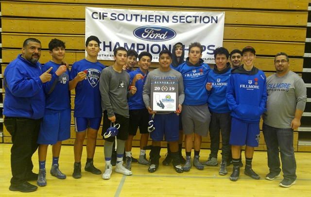 Fillmore High School Wrestling made History this past Saturday. For the first time in 31 years they competed at the Rim of the World High School Division 6 SS-CIF Dual Meet; they also earned the first League Champions in the new Citrus Coast League. Pictured (l-r) is Assistant Coach Jorge Bonilla, Davian Gonzalez, Diego Magana, Marcos “Tony” Ochoa, Adrian Scott, Gabe Gonzalez, Adrian Bonilla, Sammy Kafka, David Rivas, Abraham Santa Rosa, Nate Ocegueda, Jose Scott and Head Coach Manuel Ponce.