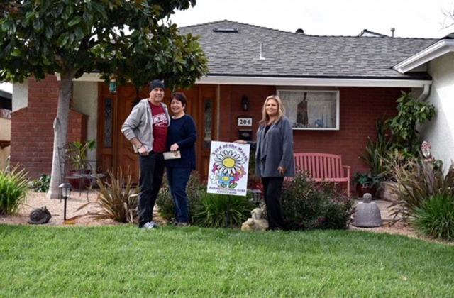 (l-r) Robert & Griselda Guerrero and Ari Larson from Civic Pride presenting the Guerrero family with their gift certificate from Otto & Sons Nursery. Photo courtesy Miranda Alonzo.