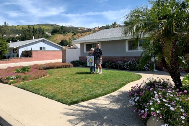 Congratulations to John and Del Beltran for being selected as the April 2019 Yard of the Month. The yard is located at 726 Fine St. in Fillmore. John takes great pride in his beautiful yard and tends to it on a daily basis. Many of the flowers in bloom were originally brought over from his mother-in-laws home in Piru, more than fifty years ago. The daisy-like flowers have spread across the yard, in a variety of colors including the original white to lavender, pink and a deep wine. They also, have a few palm trees that they were told would be miniature trees, but have proven otherwise. Succulents are also a favorite of the couple. Both John and Del enjoy their yard. They received a $40 gift certificate from Otto & Sons Nursery (1835 East Guiberson Rd. Fillmore.) The Fillmore Yard of the Month is sponsored by Fillmore Civic Pride. To nominate a yard or for more information on Fillmore Civic Pride please contact Ari Larson 805.794.7590 or petenari55@hotmail.com