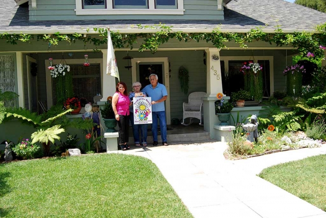 Theresa Robledo with Civic Pride Vision 2020 presents Yard of the Month to Adrian & Carol Rivera. Congratulations! This Craftsman Style Home located on 435 Fillmore Street is beautifully gardened with Geraniums, Begonias, mix of Gerber Daisies, Lavender, Amarillo flower, Flowering Christmas Cactus, Lavender Trumpet Vines, Hanging Impatience and Wisteria Vines which makes this home so inviting to sit on the front porch and enjoy chirping birds invade the garden looking for juicy grubs and shiny seeds. Thank you to Otto & Sons Nursery for the generous gift certificate to the Rivera Family.