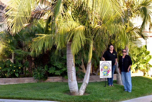 The June Yard of the Month has a tropical feel. Pictured (l-r) Lorena Jimenez and Ari Larson. Photo courtesy Ari Larson.