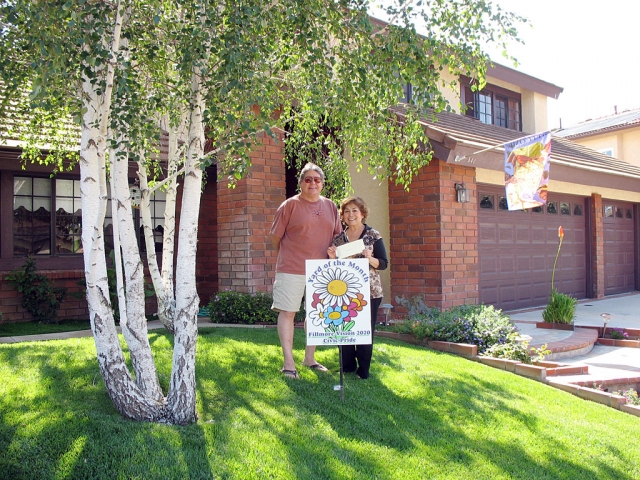Tony and Ruth Prado, of 542 Stonehenge, Fillmore, were awarded Yard of the Month for May 2009. The Prado’s front yard is beautifully shaded by three large white birch trees. One side of the yard is bordered with a row of bright orange roses. The plantings include calla lilies and a variety of brightly colored bedding flowers. There is also a blossoming torch-lily in the sidewalk planter. The Yard of the Month award is issued by Civic Pride 2020 and includes a donated Otto and Sons $25 gift certificate.